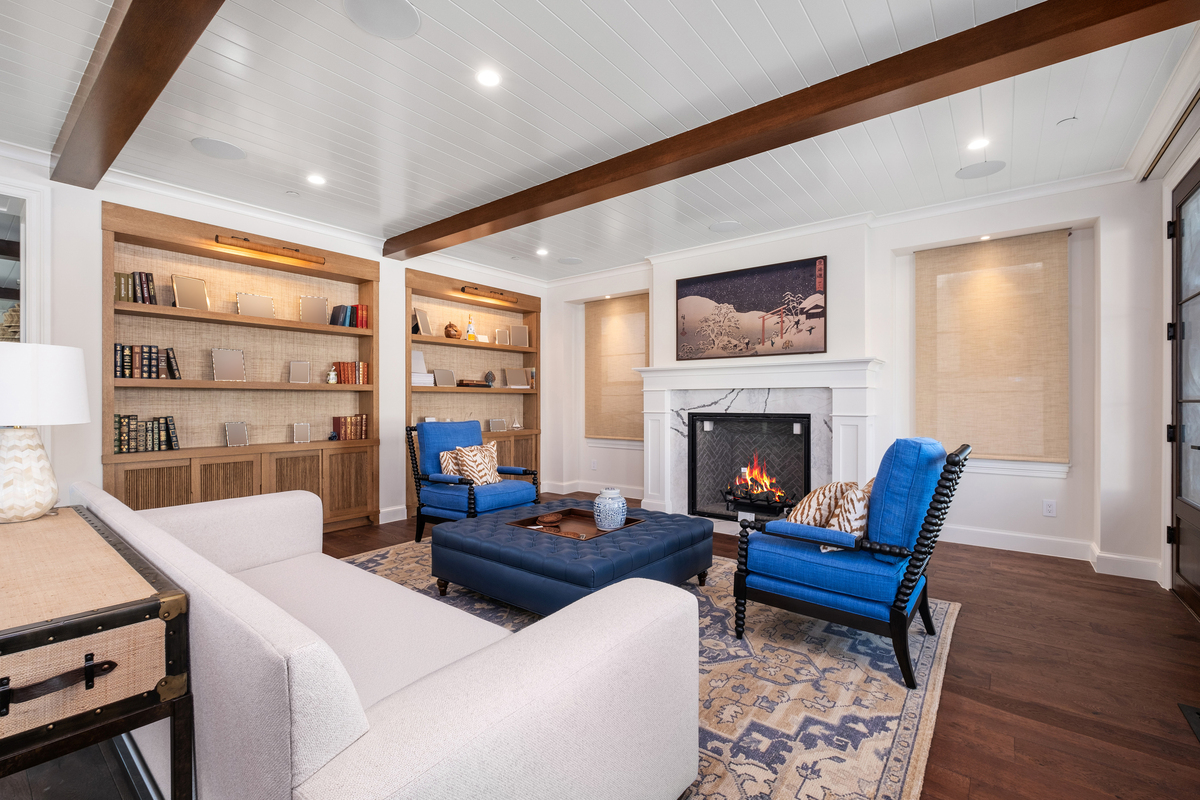 Great room with rift-oak bookcases flanking marble fireplace