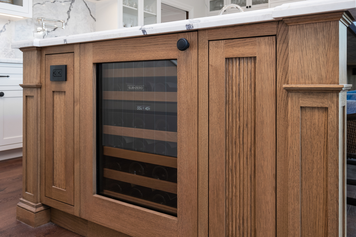 Integrated Sub-Zero wine drawer in solid-oak island end panel