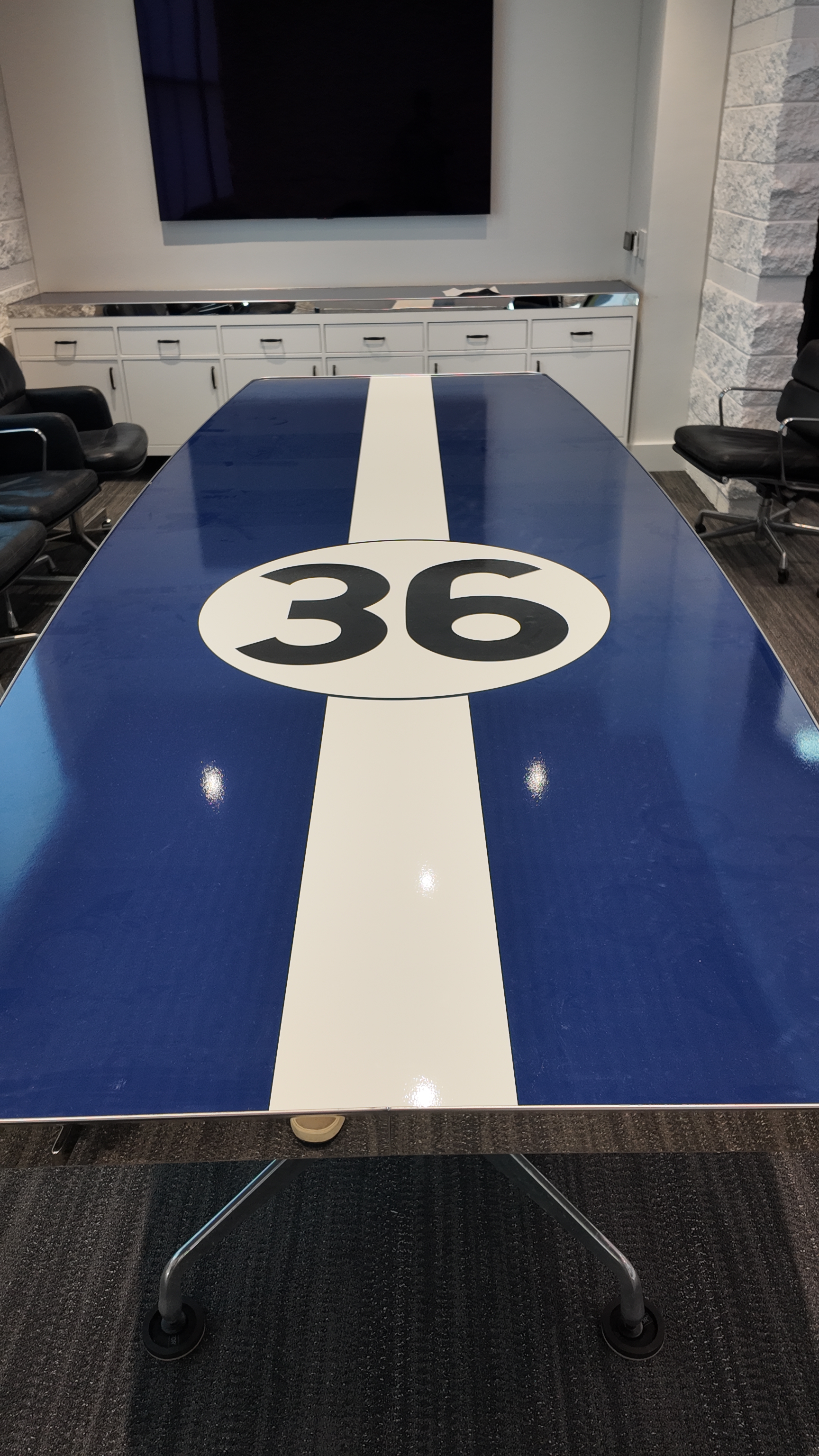 Custom racing-striped table with number 36 for a commercial office