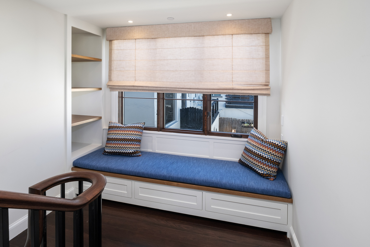Built-in window seat with storage base and shiplap surround